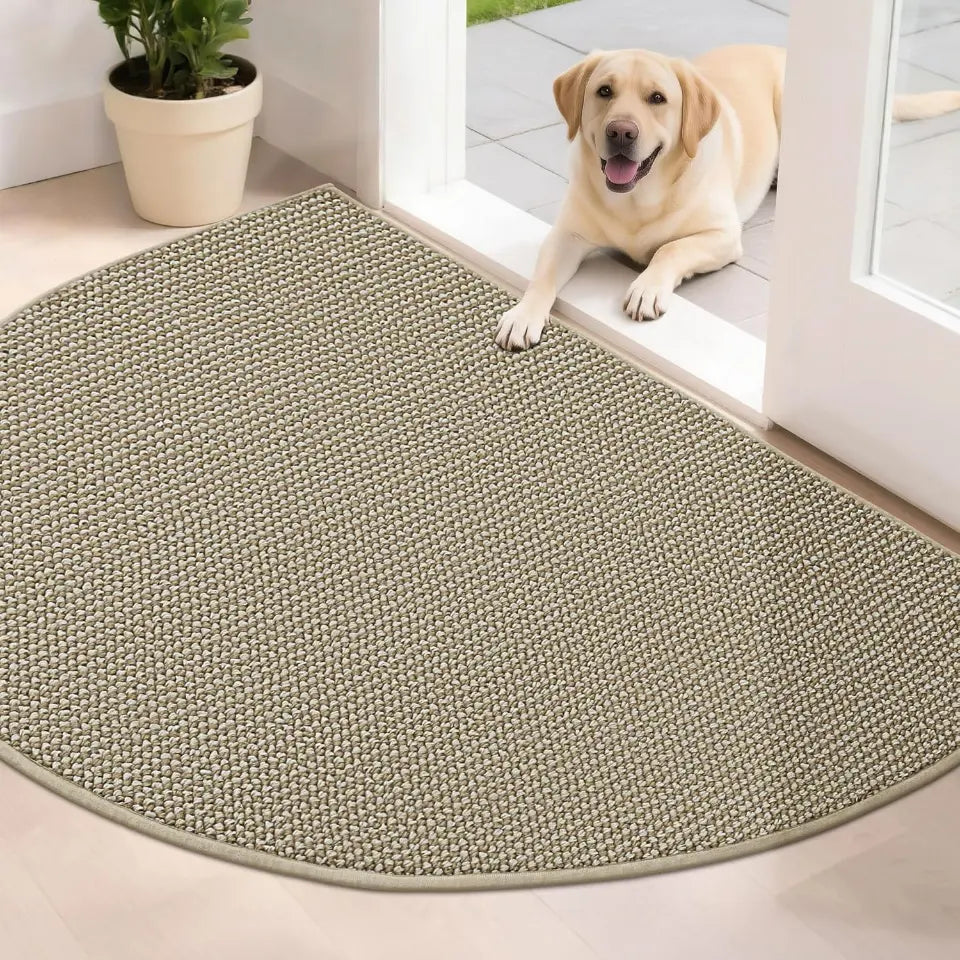 Dog lying on a half-circle light beige rug in a home setting.