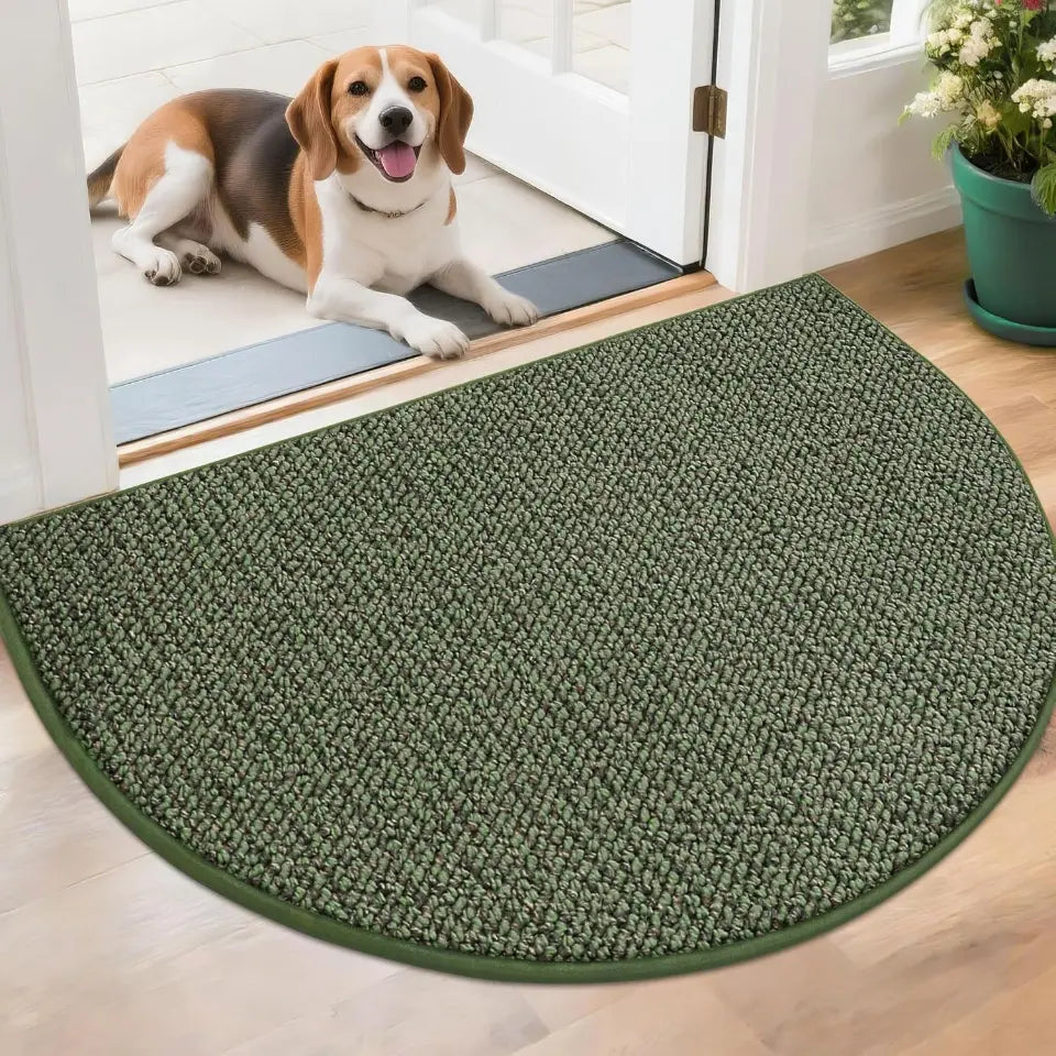 Green door mat in front of a glass door with a dog on the other side