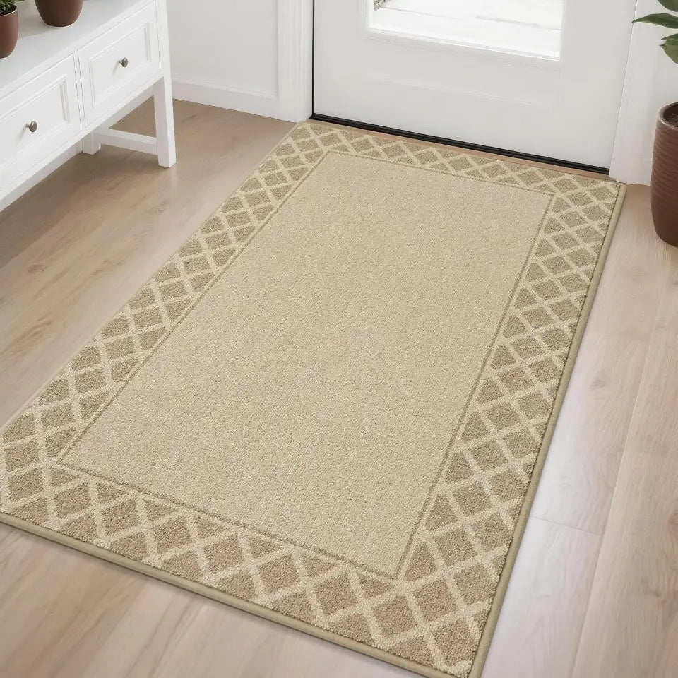 Beige area rug with geometric border on a wooden floor