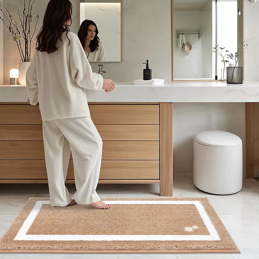 Woman's Foot Stepping on a Brown Framed, Embroidered Floral-Print Tufted Bath Mat